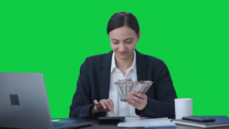 Indian-business-woman-with-attitude-counting-money-Green-screen