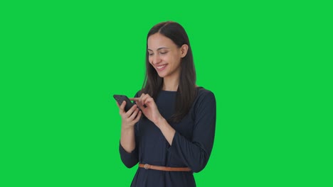 Happy-Indian-girl-scrolling-through-phone-Green-screen