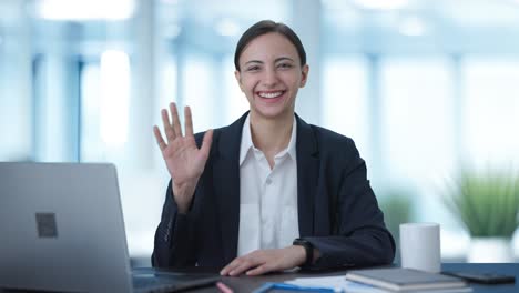 Happy-Indian-business-woman-waving-Hi-to-the-camera