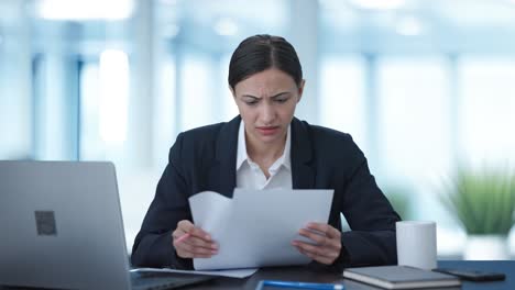 Frustrated-Indian-business-woman-signing-a-contract