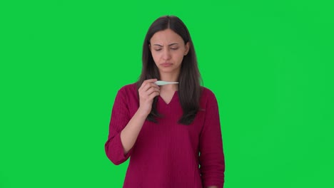 Sick-Indian-woman-using-thermometer-to-check-fever-Green-screen
