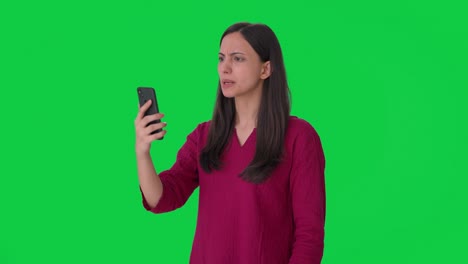 Angry-Indian-woman-shouting-on-someone-on-video-call-Green-screen