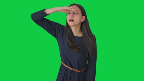 Curious-Indian-girl-searching-someone-Green-screen