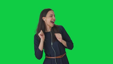 Happy-Indian-girl-listening-to-songs-through-earphone-and-dancing-Green-screen