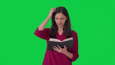 Confused-Indian-woman-reading-a-book-Green-screen