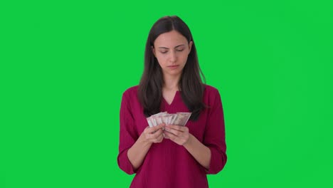 Confused-Indian-woman-counting-money-Green-screen