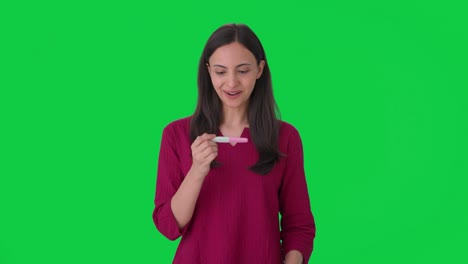Happy-Indian-woman-gets-her-pregnancy-test-positive-Green-screen