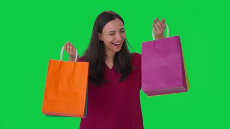 Happy-Indian-woman-with-shopping-bags-Green-screen