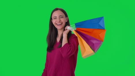 Happy-Indian-woman-posing-with-shopping-bags-Green-screen