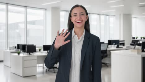 Happy-Indian-business-woman-waving-Hi-to-the-camera