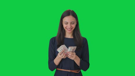 Happy-Indian-girl-counting-money-Green-screen