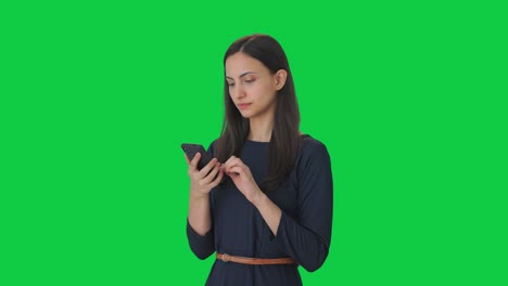 Indian-girl-scrolling-through-phone-Green-screen