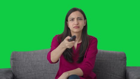 Indian-woman-trying-to-fix-TV-remote-Green-screen
