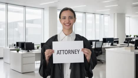 Happy-Indian-female-lawyer-holding-ATTORNEY-banner