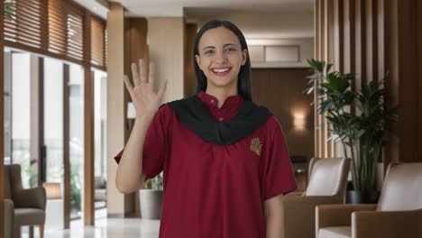 Happy-Indian-female-housekeeper-waving-hello
