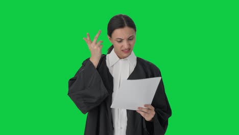 Confused-Indian-female-lawyer-reading-case-files-Green-screen