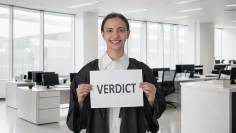 Happy-Indian-female-lawyer-holding-VERDICT-banner