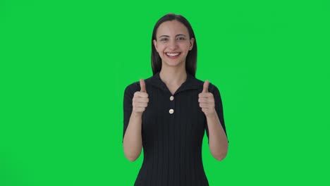 Happy-Indian-female-news-anchor-showing-thumbs-up-Green-screen
