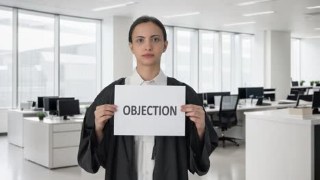Sad-Indian-female-lawyer-holding-OBJECTION-banner