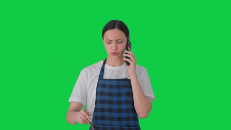 Angry-Indian-housewife-shouting-on-call-while-making-food-Green-screen