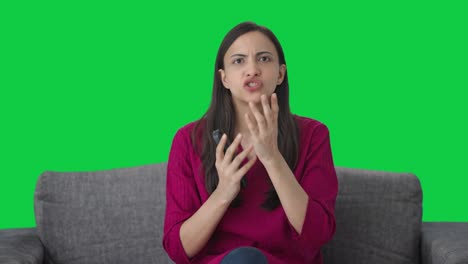 Indian-woman-sees-a-shocking-news-on-TV-Green-screen