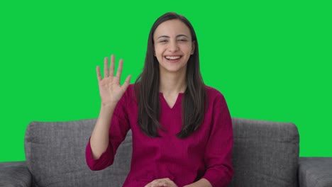 Happy-Indian-woman-waving-Hi-to-the-camera-Green-screen