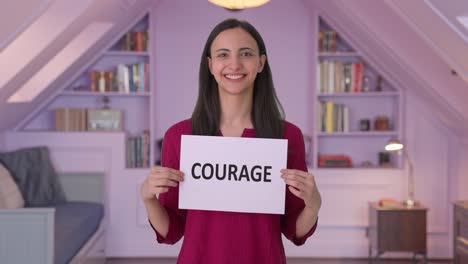 Happy-Indian-woman-holding-COURAGE-banner