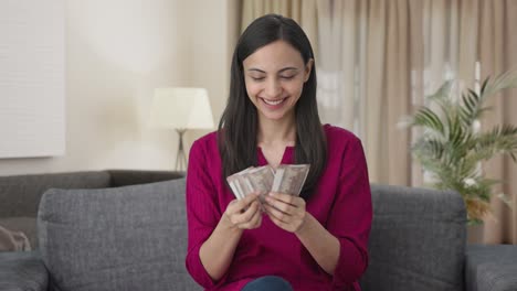 Happy-Indian-woman-counting-money