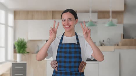 Happy-Indian-housewife-showing-victory-sign