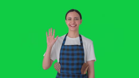 Happy-Indian-housewife-waving-hello-Green-screen