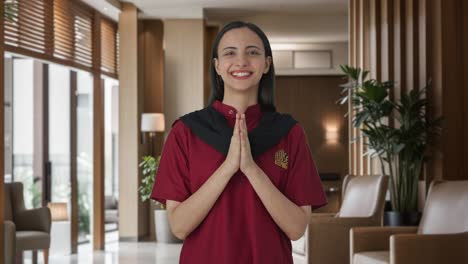 Happy-Indian-female-housekeeper-welcoming-guests