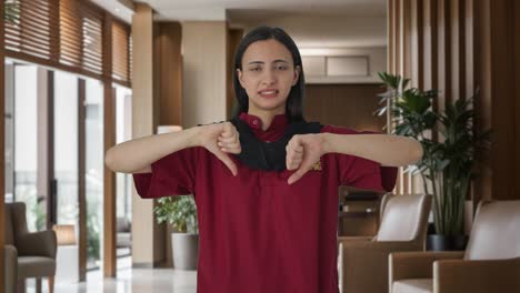 Upset-Indian-female-housekeeper-showing-thumbs-down