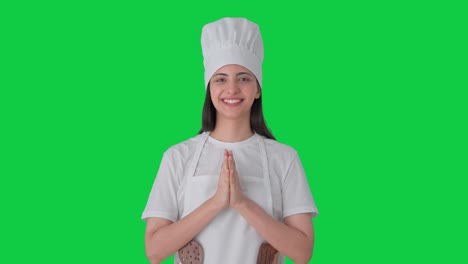 Happy-Indian-female-professional-chef-doing-Namaste-Green-screen