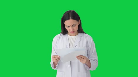 Stressed-Indian-female-scientist-reading-reports-Green-screen