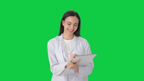 Happy-Indian-female-scientist-taking-notes-Green-screen