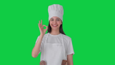 Happy-Indian-female-professional-chef-showing-okay-sign-Green-screen