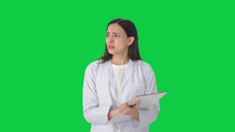 Angry-Indian-female-scientist-taking-notes-Green-screen