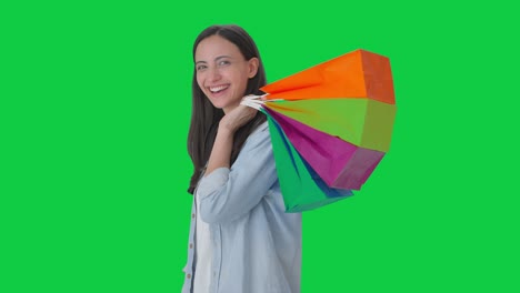 Happy-Indian-girl-posing-with-shopping-bags-Green-screen