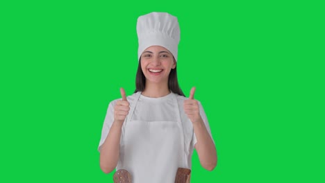Happy-Indian-female-professional-chef-showing-thumbs-up-Green-screen