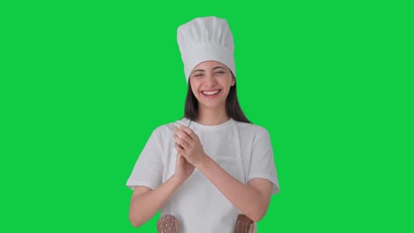 Happy-Indian-female-professional-chef-clapping-and-appreciating-Green-screen
