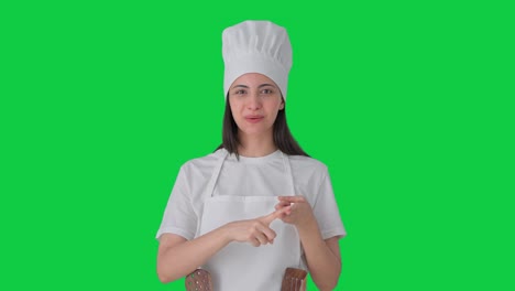 Happy-Indian-female-professional-chef-talking-to-the-camera-Green-screen