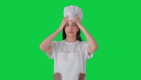 Indian-female-professional-chef-wearing-hat-and-apron-Green-screen