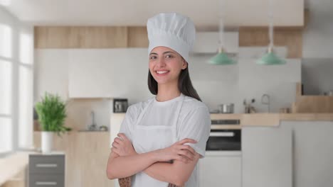 Portrait-of-Happy-Indian-female-professional-chef-standing-crossed-hands