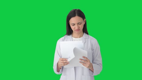 Confused-Indian-female-scientist-reading-reports-Green-screen