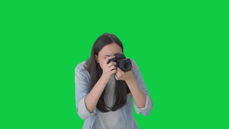 Indian-girl-clicking-photos-using-a-camera-Green-screen