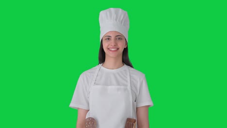 Happy-Indian-female-professional-chef-smiling-Green-screen