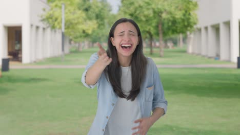 Happy-Indian-girl-laughing-on-someone