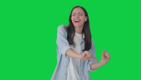Happy-Indian-girl-listening-to-songs-and-dancing-Green-screen
