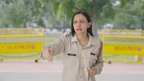 Angry-Indian-female-police-officer-using-whistle-to-call-someone