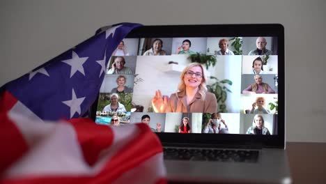 Animation-of-American-flag-laptop-computer-in-the-background.-American-society-diversity-concept-digital-composition.